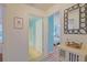 Hallway view of bathroom and bedroom with bright blue accent walls at 14004 Se 94Th Ave, Summerfield, FL 34491