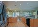 Open kitchen featuring wood cabinets, stainless steel appliances, and a seamless flow to the dining area at 14004 Se 94Th Ave, Summerfield, FL 34491