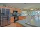 Spacious kitchen boasts stainless steel appliances, wood cabinets, and ample countertop space at 14004 Se 94Th Ave, Summerfield, FL 34491