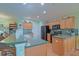 This kitchen features wood cabinets, granite counters, and stainless steel appliances at 14004 Se 94Th Ave, Summerfield, FL 34491