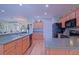 Beautiful open-concept kitchen with stainless steel appliances, granite countertops, and ample cabinet space at 14004 Se 94Th Ave, Summerfield, FL 34491