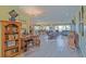 Open floor plan featuring a spacious living room, chandelier, desk, bookcases, and leather seating at 14004 Se 94Th Ave, Summerfield, FL 34491