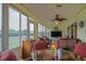 Expansive screened-in patio with table, seating, and ceiling fan. Great for outdoor dining and entertaining at 14004 Se 94Th Ave, Summerfield, FL 34491
