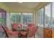 Comfortable screened-in patio with outdoor furniture, views and natural light for relaxing and dining at 14004 Se 94Th Ave, Summerfield, FL 34491