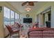 Large screened patio with seating, a TV, and outdoor views. Enjoy relaxed outdoor living at 14004 Se 94Th Ave, Summerfield, FL 34491