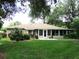 Well-maintained backyard with lush green grass, mature trees and a screened patio at 14561 Sw 112Th Cir, Dunnellon, FL 34432