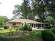 Well-maintained backyard with lush green grass, mature trees and a screened patio at 14561 Sw 112Th Cir, Dunnellon, FL 34432