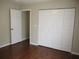 Bedroom boasts wood floors and closet with paneled doors at 14561 Sw 112Th Cir, Dunnellon, FL 34432