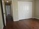 Empty bedroom with hardwood flooring and closet doors at 14561 Sw 112Th Cir, Dunnellon, FL 34432