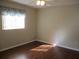 Empty bedroom showcasing hardwood flooring and natural light at 14561 Sw 112Th Cir, Dunnellon, FL 34432