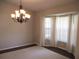 Dining room features elegant chandelier, neutral paint, and a large bay window providing plenty of natural light at 14561 Sw 112Th Cir, Dunnellon, FL 34432