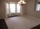 Dining room with neutral carpet, bay window, and decorative light fixture at 14561 Sw 112Th Cir, Dunnellon, FL 34432