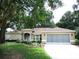 Lovely single story home with a well manicured lawn, mature trees and a two car garage at 14561 Sw 112Th Cir, Dunnellon, FL 34432