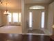 Foyer and dining room with neutral carpet, bright light fixture, and hardwood floors at 14561 Sw 112Th Cir, Dunnellon, FL 34432