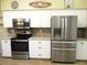 Well-equipped kitchen with stainless steel appliances, white cabinetry, and granite countertops at 14561 Sw 112Th Cir, Dunnellon, FL 34432