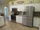 Stylish kitchen with stainless steel appliances, granite countertops and tile floors at 14561 Sw 112Th Cir, Dunnellon, FL 34432