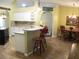 Charming kitchen with white cabinets, granite countertops, and breakfast bar at 14561 Sw 112Th Cir, Dunnellon, FL 34432