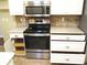 Updated kitchen with stainless steel appliances, granite counters, and white cabinetry at 14561 Sw 112Th Cir, Dunnellon, FL 34432