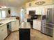 Modern kitchen with stainless steel appliances, tile flooring, and a center island at 14561 Sw 112Th Cir, Dunnellon, FL 34432