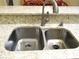 Close-up of a stainless steel double sink with granite countertops at 14561 Sw 112Th Cir, Dunnellon, FL 34432