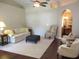 Bright living room features a ceiling fan, plush seating, and hardwood floors at 14561 Sw 112Th Cir, Dunnellon, FL 34432