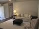 Bright living room with plush seating and a comfortable ottoman at 14561 Sw 112Th Cir, Dunnellon, FL 34432