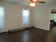 Spacious main bedroom showcases hardwood floors, neutral paint, and a ceiling fan at 14561 Sw 112Th Cir, Dunnellon, FL 34432