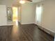 Open main bedroom features hardwood floors, a ceiling fan, and ensuite bathroom access at 14561 Sw 112Th Cir, Dunnellon, FL 34432