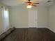 Comfortable main bedroom features hardwood floors, a ceiling fan, and white sheer curtains at 14561 Sw 112Th Cir, Dunnellon, FL 34432