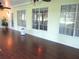 Sun room featuring hardwood flooring, many windows, and ceiling fans at 14561 Sw 112Th Cir, Dunnellon, FL 34432