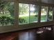 Sun room featuring scenic outside view, many windows, and hardwood flooring at 14561 Sw 112Th Cir, Dunnellon, FL 34432