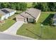 A high-angle view shows a charming, single-story home with well-maintained landscaping in a suburban neighborhood at 160 Hickory Course Loop, Ocala, FL 34472