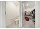 Half bathroom leading to a walk-in closet with ample storage space and shelving for organization at 160 Hickory Course Loop, Ocala, FL 34472
