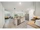 A modern kitchen with stainless steel appliances, a large island, and lots of natural light at 160 Hickory Course Loop, Ocala, FL 34472