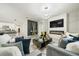 Open-concept living room boasts a fireplace, modern lighting, and stylish decor, creating an inviting atmosphere at 160 Hickory Course Loop, Ocala, FL 34472