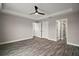 Spacious bedroom featuring luxury vinyl plank flooring, tray ceiling, and ample closet space at 20 Emerald Trl, Ocala, FL 34472