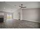 Spacious living room with sliding glass doors leading to backyard and open to the kitchen at 20 Emerald Trl, Ocala, FL 34472