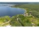 Aerial view showcasing the home's lakeside location surrounded by lush greenery at 23797 Ne 189Th St, Fort Mc Coy, FL 32134