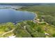Aerial view showcasing the property boundaries, lakeside location and surrounding greenery at 23797 Ne 189Th St, Fort Mc Coy, FL 32134