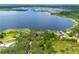 Breathtaking aerial view of lakefront property featuring serene waters, lush greenery, private dock, and a tranquil atmosphere at 23797 Ne 189Th St, Fort Mc Coy, FL 32134