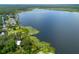 Expansive aerial view of a lakefront community featuring tranquil waters, docks, lush greenery and natural beauty at 23797 Ne 189Th St, Fort Mc Coy, FL 32134