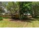 View of backyard with a shed covered in Spanish moss and a golf cart parked under the awning at 23797 Ne 189Th St, Fort Mc Coy, FL 32134