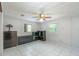 Neutral bedroom with tile flooring, ceiling fan, and lots of natural light from two windows at 23797 Ne 189Th St, Fort Mc Coy, FL 32134