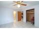 Bedroom featuring tile flooring, a ceiling fan, access to a bathroom and closet at 23797 Ne 189Th St, Fort Mc Coy, FL 32134
