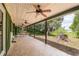 Inviting covered patio features ceiling fans and a seating area with views of lush green space and mature trees at 23797 Ne 189Th St, Fort Mc Coy, FL 32134