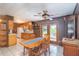 The dining room features a wooden table, tiled floors, wood paneling, and outdoor access at 23797 Ne 189Th St, Fort Mc Coy, FL 32134