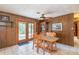 Inviting dining room with wood-paneled walls and a classic chandelier above the table at 23797 Ne 189Th St, Fort Mc Coy, FL 32134