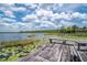 Picturesque dock featuring seating area, overlooking the tranquil lake and lush greenery at 23797 Ne 189Th St, Fort Mc Coy, FL 32134
