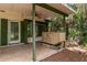 Covered patio featuring ceiling fan, overlooking the lake and lush landscaping at 23797 Ne 189Th St, Fort Mc Coy, FL 32134