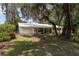 Charming single-story home featuring a manicured lawn and a convenient garage entrance at 23797 Ne 189Th St, Fort Mc Coy, FL 32134